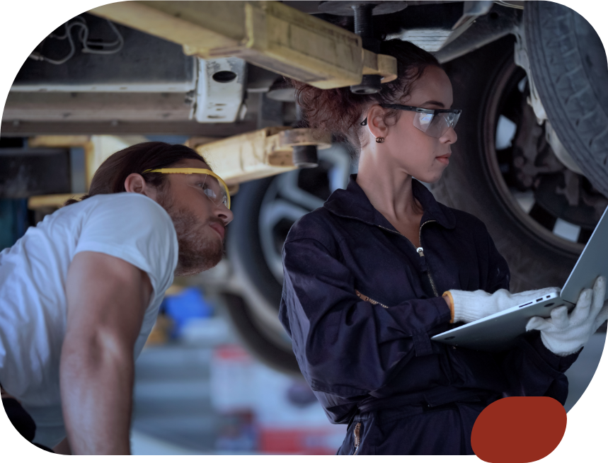 man and woman mechanics diagnosing car