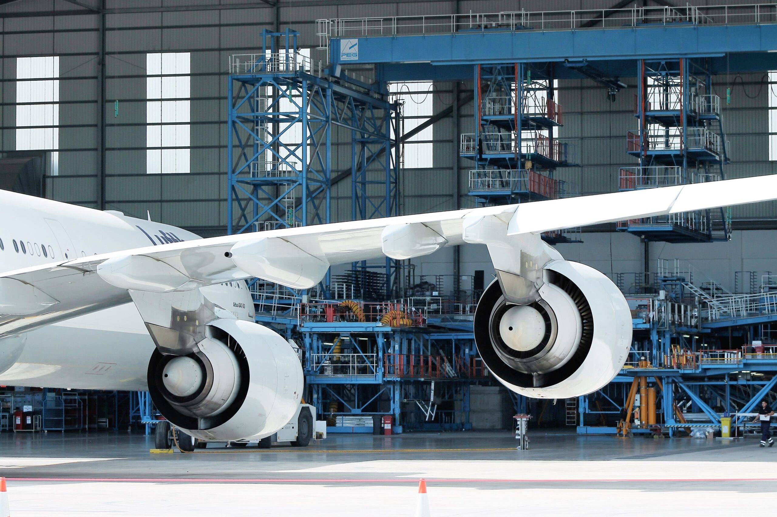 commercial plane parked in large warehouse